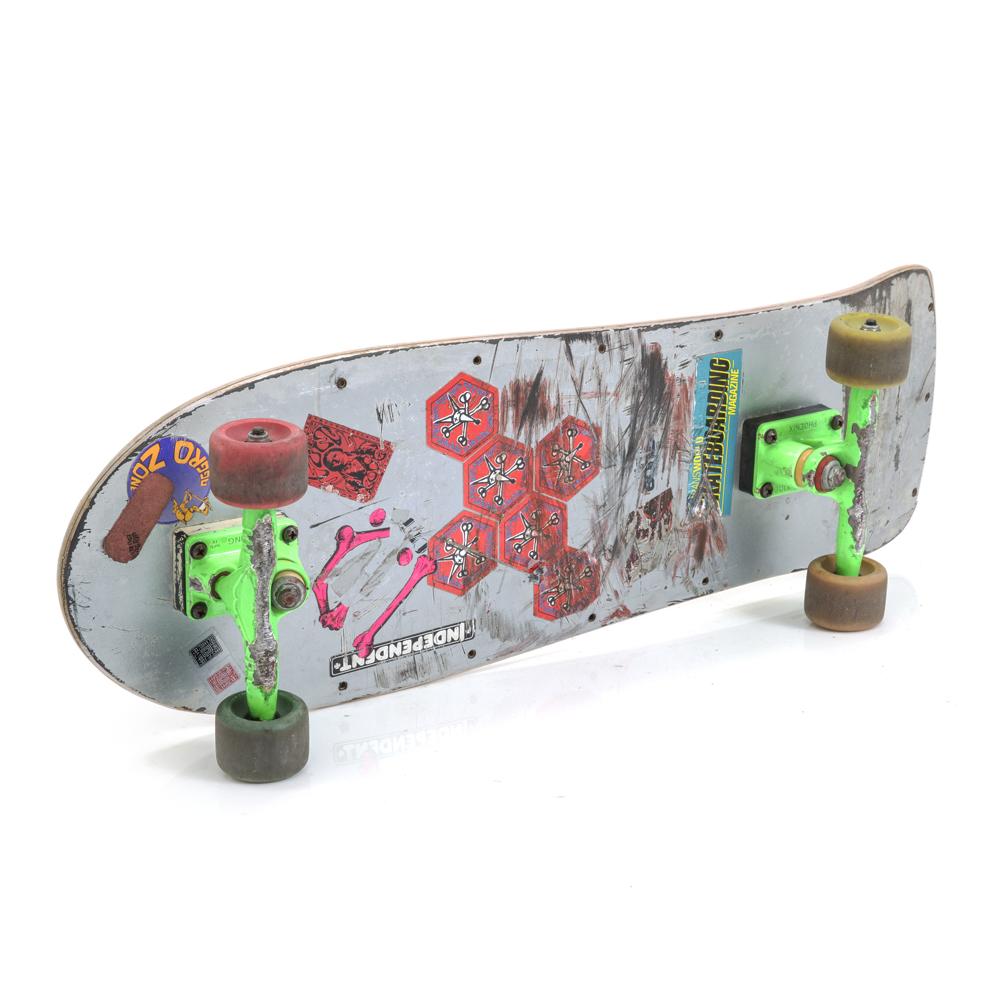 Messy Metal Skateboard with Green Trucks, Red & Yellow Wheels