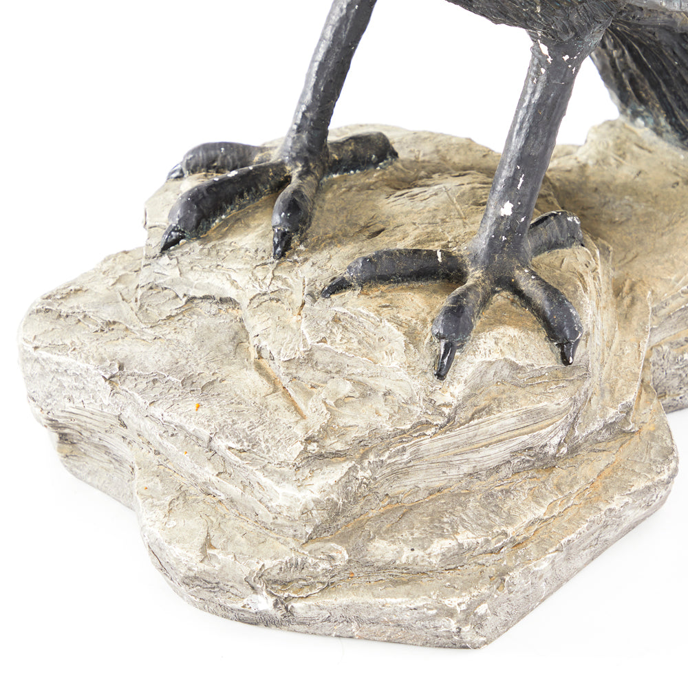 Crow Perched on Rock Sculpture