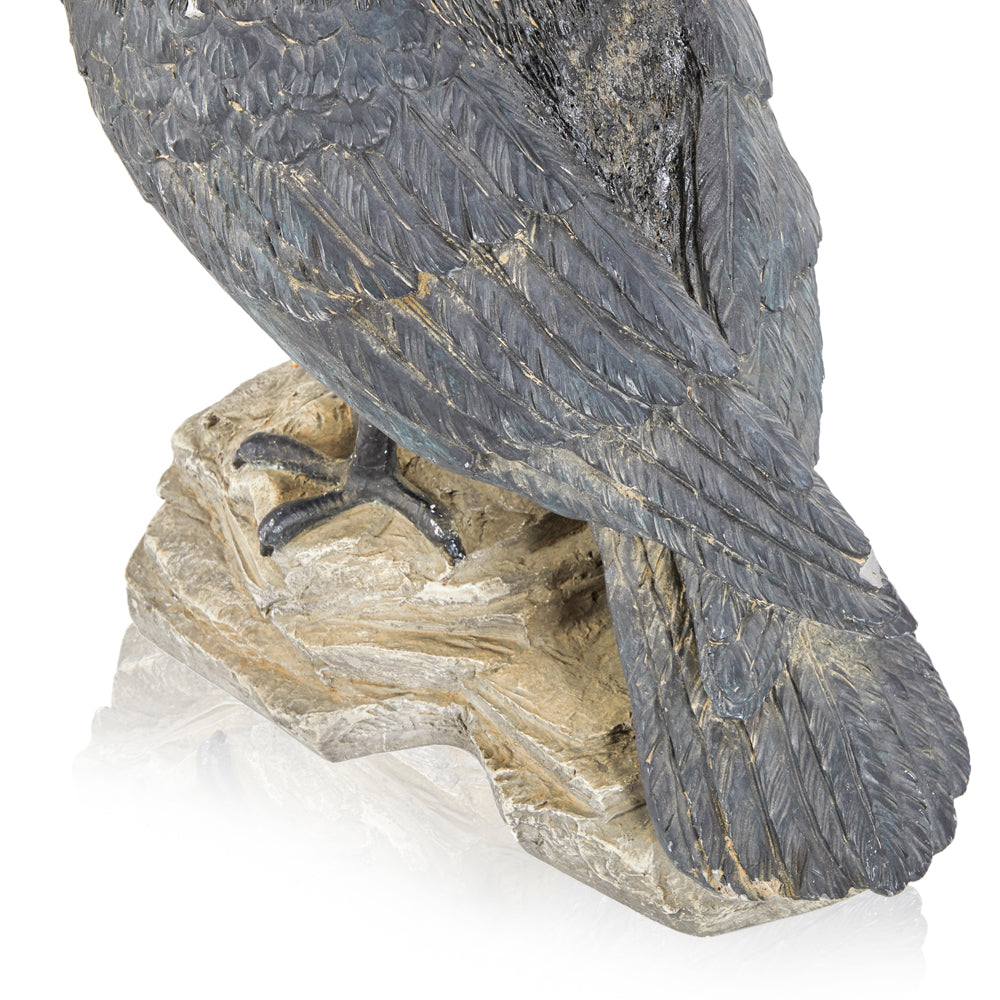 Crow Perched on Rock Sculpture